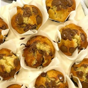 Rows of ready homemade banana muffins with choc chips.