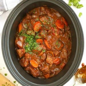 Beef Stifado, a Greek-style beef stew with vegetables in a slow cooker, ready to serve.