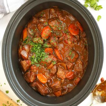 Beef Stifado, a Greek-style beef stew with vegetables in a slow cooker, ready to serve.