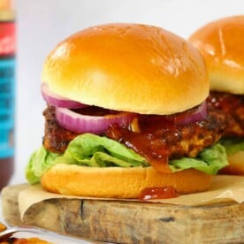 Homemade Chicken Tikka Burger on a serving board, ready to eat.