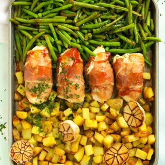 Recipe for bacon wrapped chicken served with potatoes and green beans.