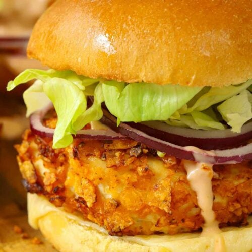 A succulent chicken burger with a crispy coating in a brioche bun, filled with salad.