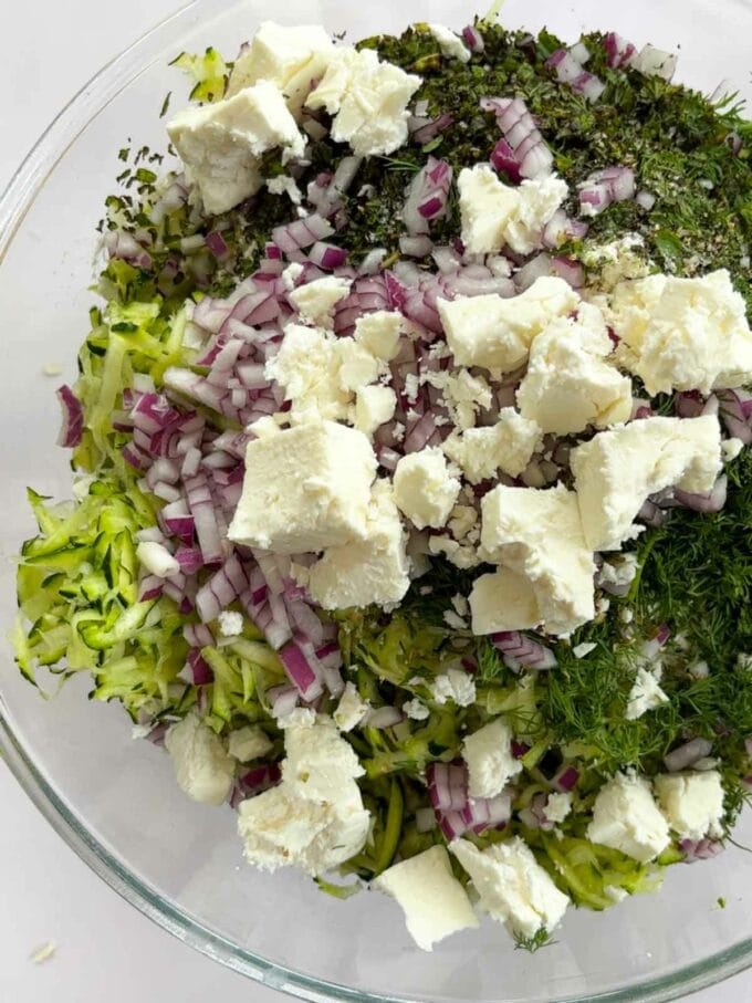 How to make Courgette Fritters. Step 2. Mix the ingredients together in a bowl.