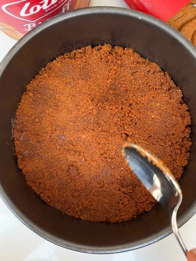 How to make Biscoff Cheesecake. Step 2. Press base into a tin.