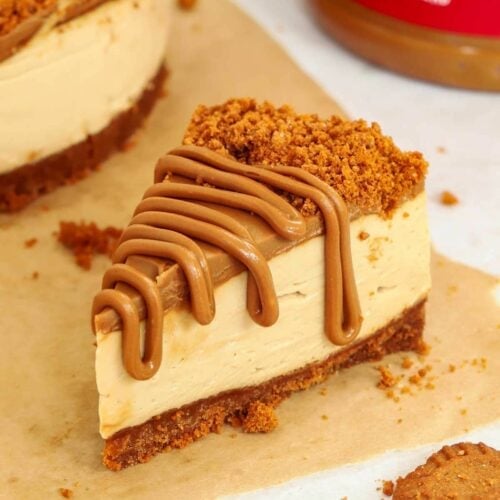 A slice of Biscoff cheesecake with a Biscoff butter topping drizzled over.