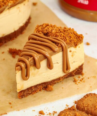 A slice of homemade Biscoff Cheesecake with a base, filling and topping drizzled over.