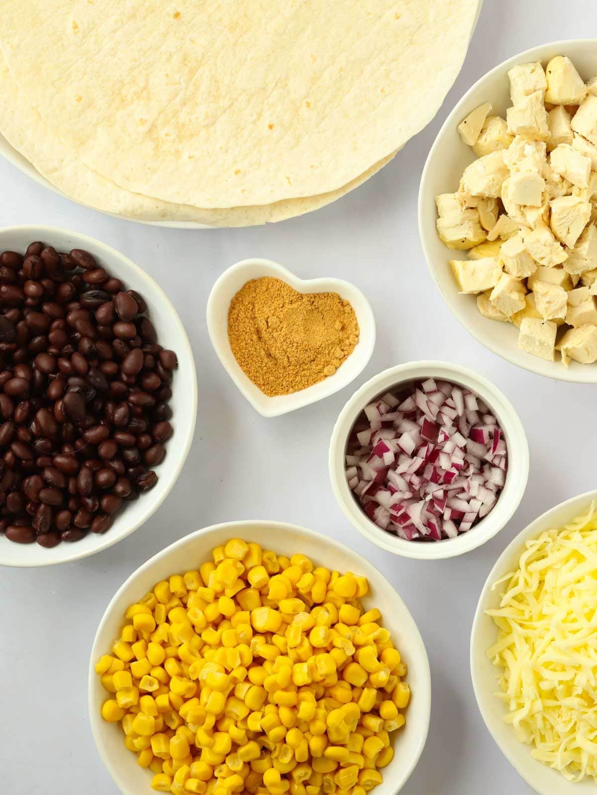 Ingredients for making Chicken Quesadillas laid out on a counter.