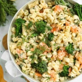 A big bowl full of smoked salmon pasta with broccoli.