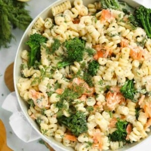 A big bowl full of smoked salmon pasta with broccoli.