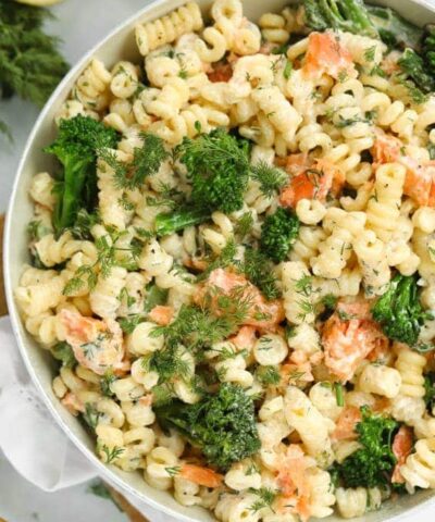 A big bowl full of smoked salmon pasta with broccoli.