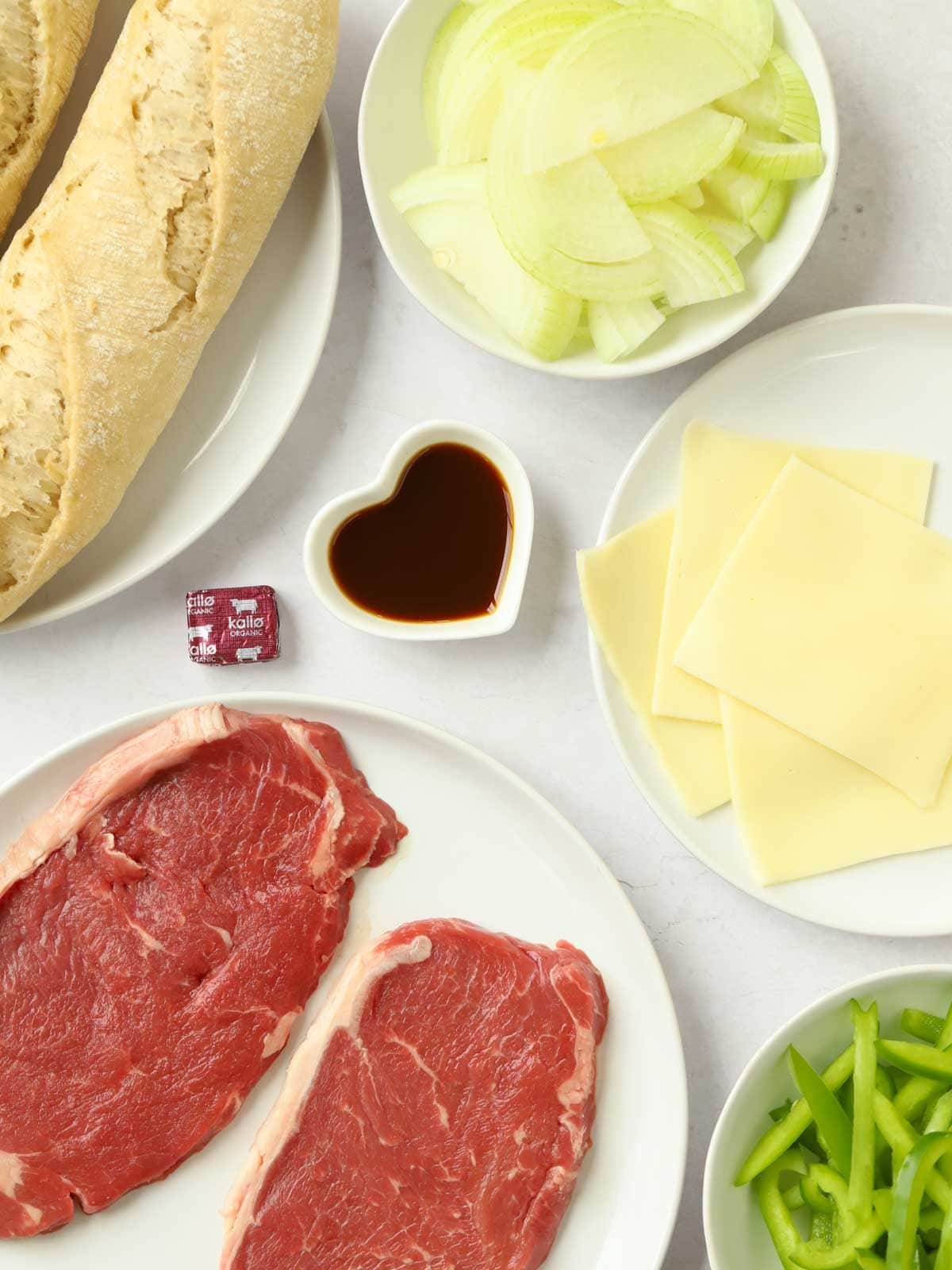 Ingredients for a Philly Cheesesteak laid on a counter.