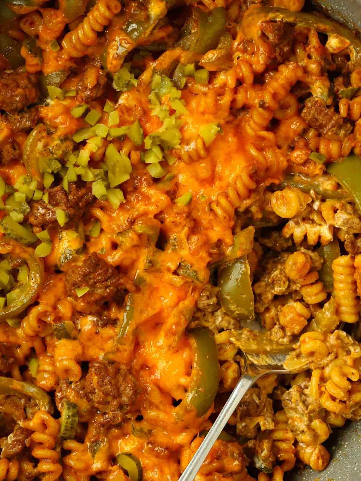 A close up of a pot of mince, pasta and cheese for the recipe Cheeseburger Pasta.