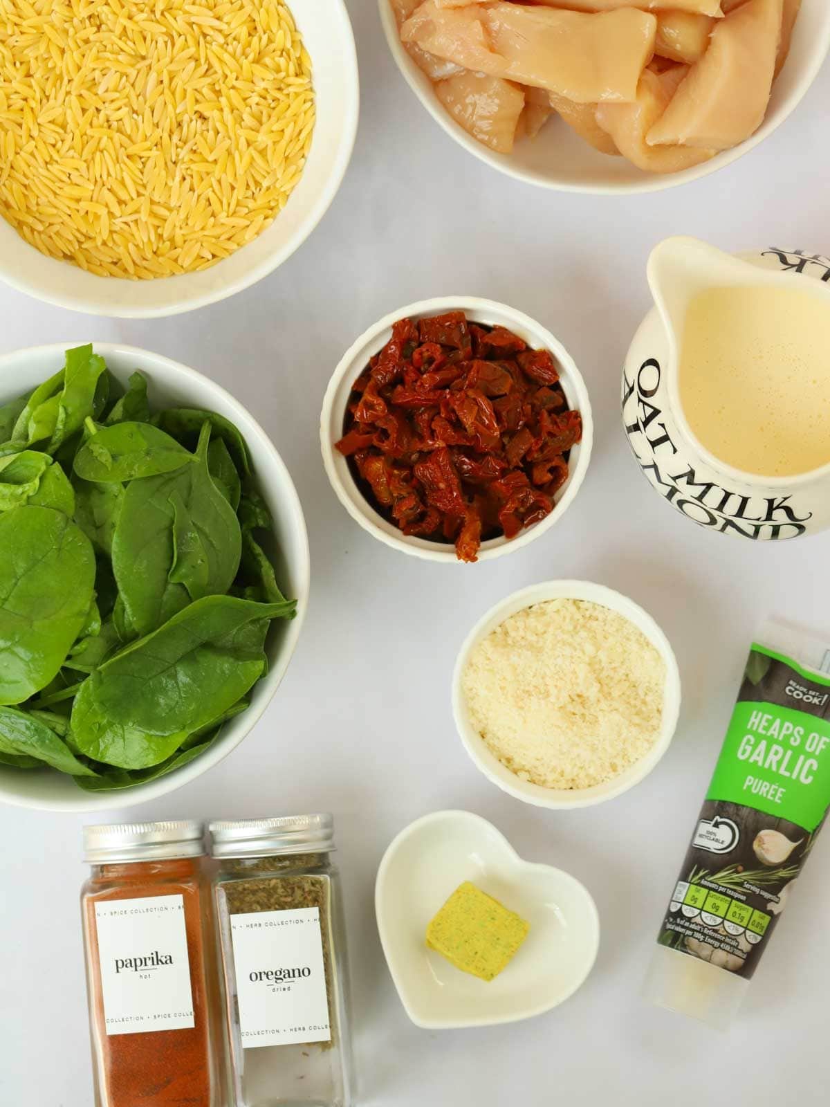 The ingredients for Marry Me Chicken Orzo recipe laid out on a counter top.