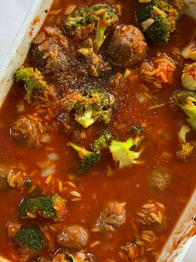 How to make Meatball Orzo Bake, step 2. Broccoli, orzo and meatballs in a dish, ready to go in the oven.