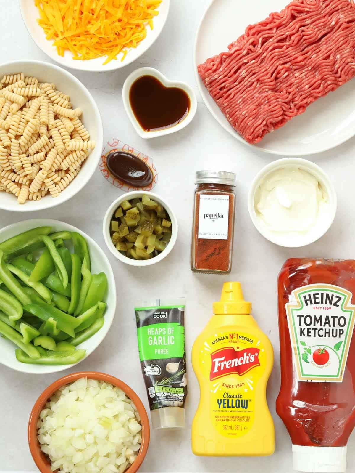 The ingredients for a Cheeseburger Pasta recipe all laid out on a counter.