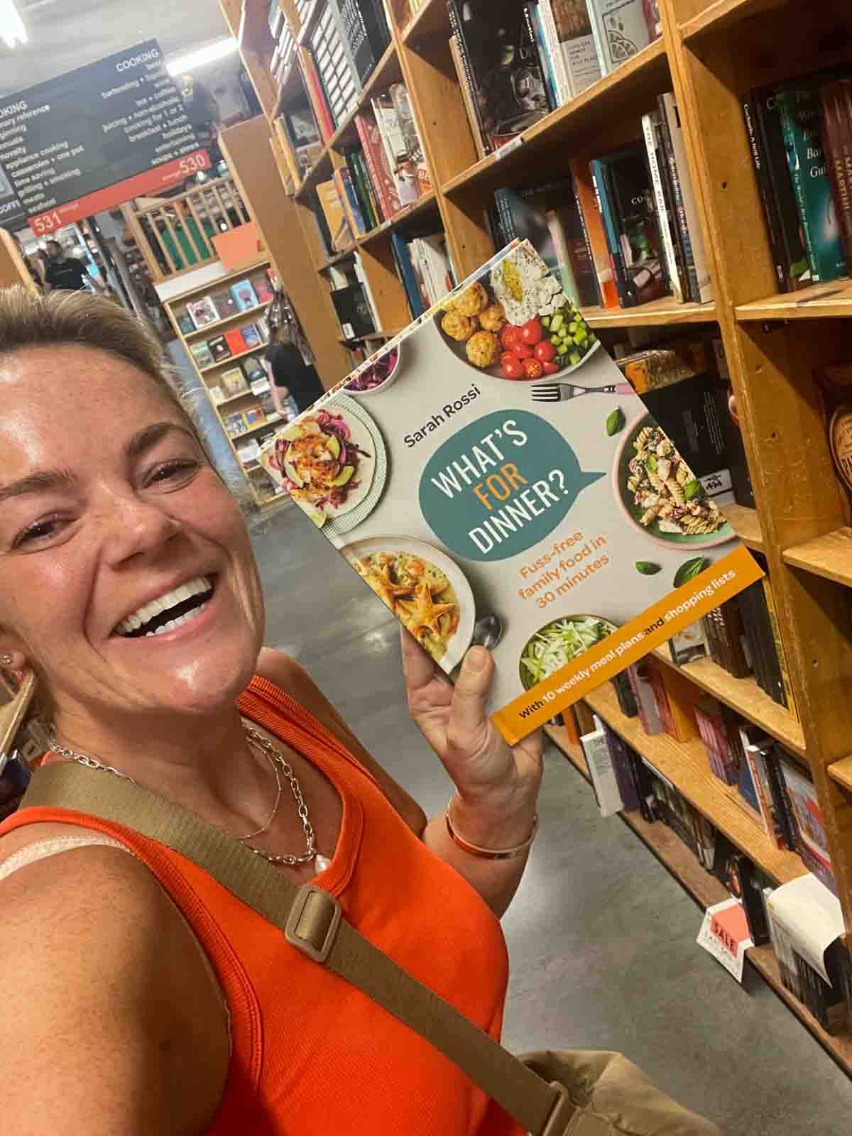 Sarah Rossi holding her book 'What's For Dinner?' at Powell Books in Portland.