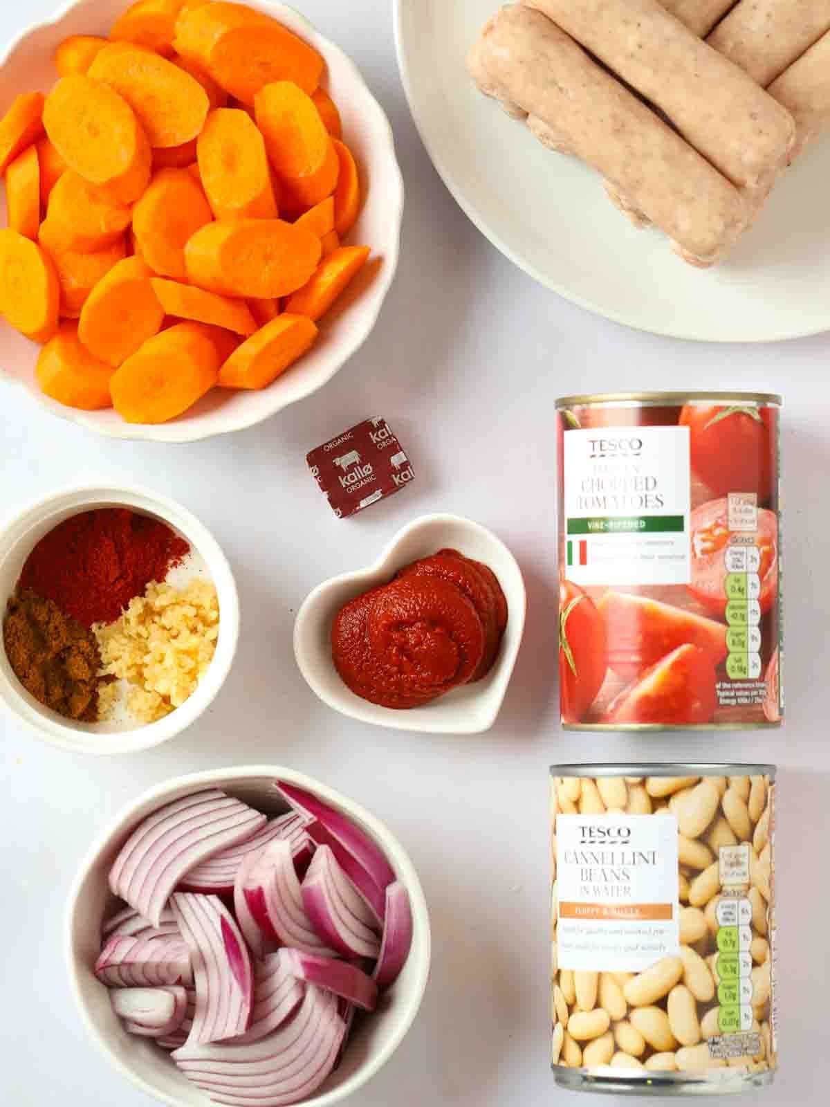 The ingredients for slow cooker sausage casserole laid out on a counter top.