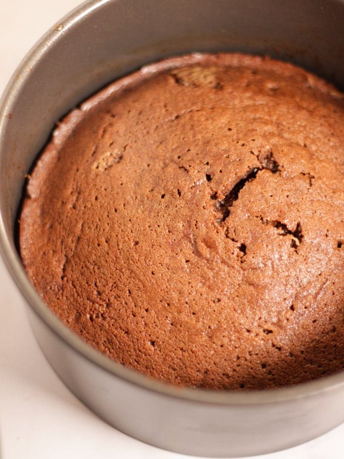 A baked chocolate cake in a tin, undecorated for the next step in the recipe for Chocolate Orange Cake.