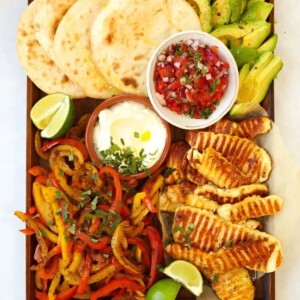 Halloumi fajitas recipe on a board with tortilla wraps avocado and salsa.