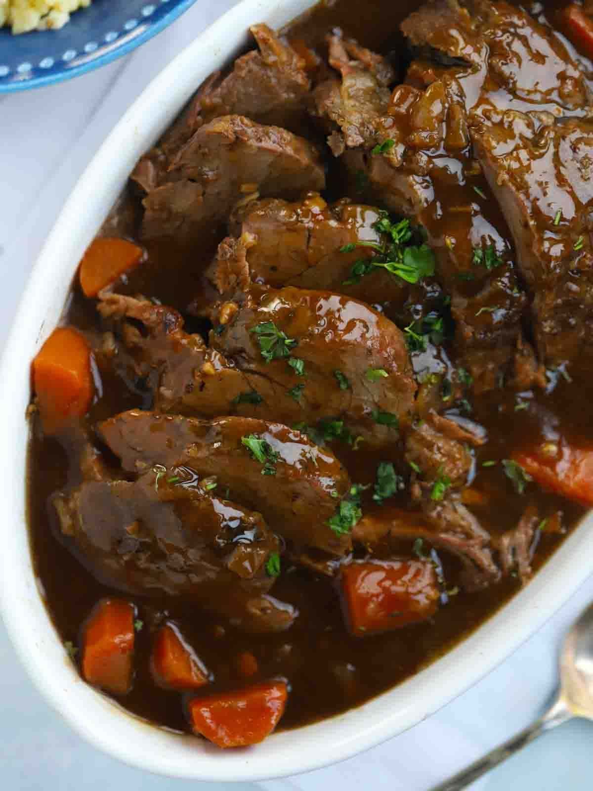 Cooked Slow Cooker Beef Joint, ready to serve on a platter.