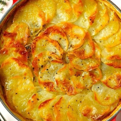 A pan filled with golden topped Boulangere potatoes.