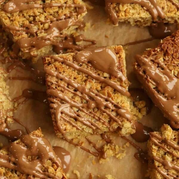 Melted chocolate drizzled over pieces of just baked flapjacks.