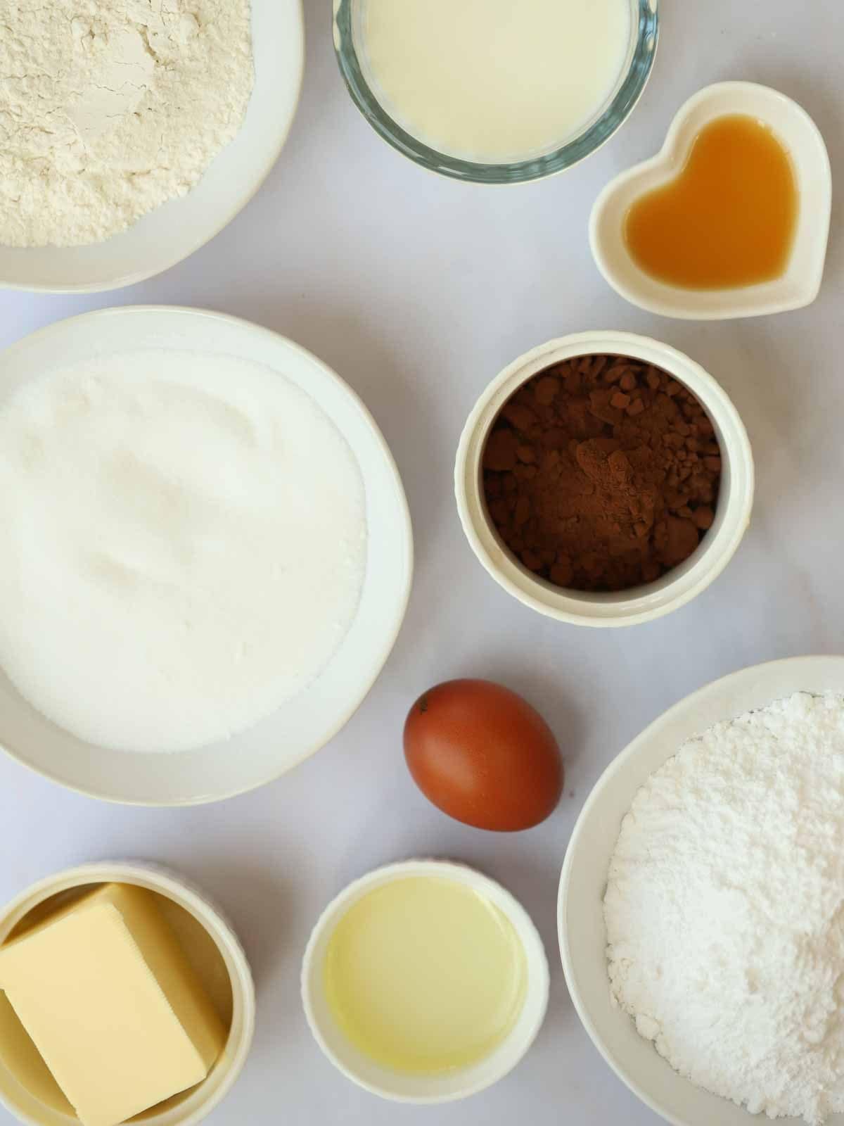 The ingredients for chocolate cupcakes laid out on a counter top.