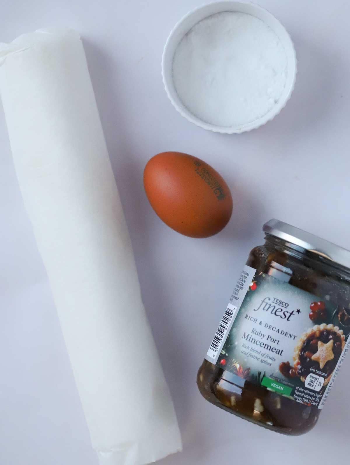 The ingredients for mince pies laid out on a counter top.