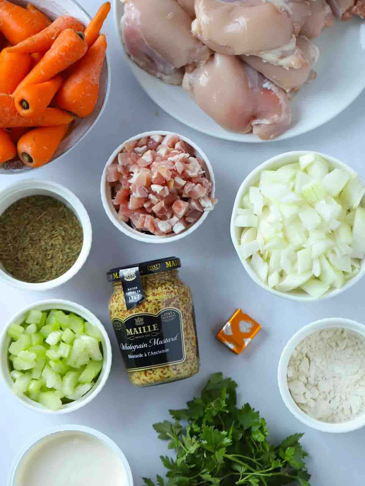 The ingredients for a slow cooker chicken casserole laid out on a counter top.