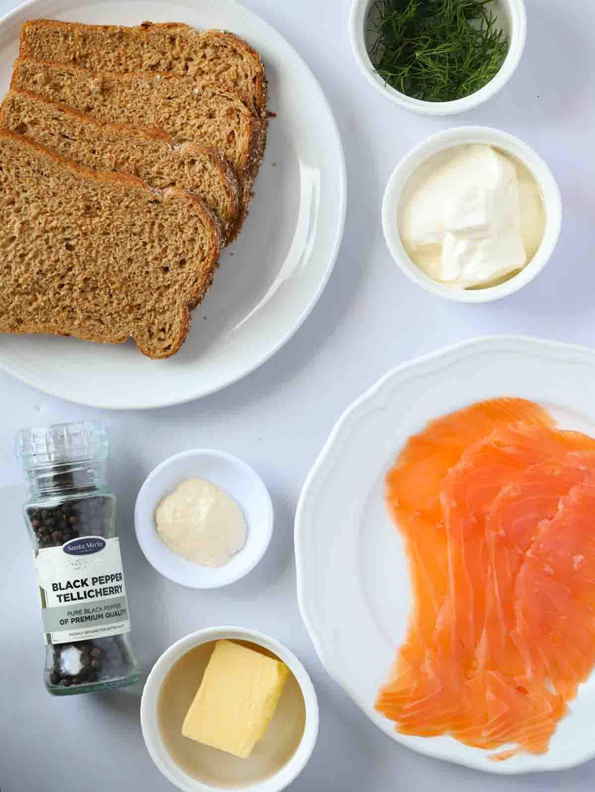 Ingredients for smoked salmon canapes laid out on a counter top.