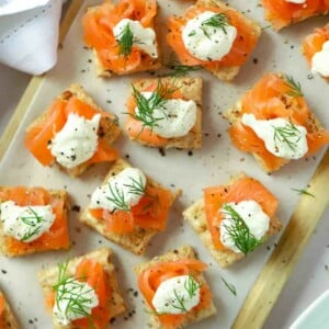 Perfect party food on a serving board. Smoked Salmon Canapés topped with creme fraiche and dill.