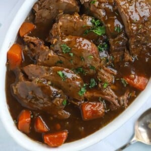 A plate full of tender roast beef, made in the slow cooker. Slow Cooker Beef Joint Recipe.