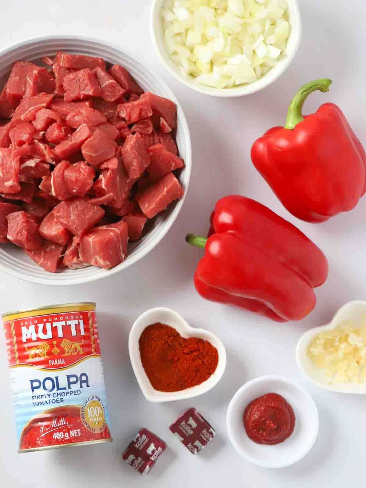 The ingredients for slow cooker beef goulash laid out on a counter.