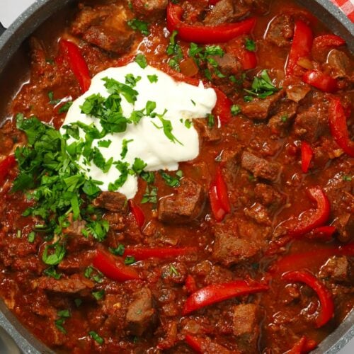 A pan filled with beef goulash, cooked in the slow cooker.