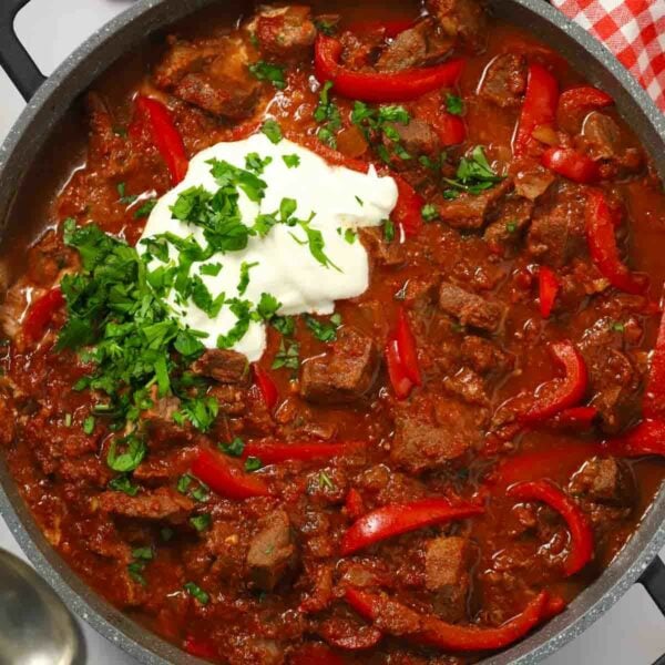 Close up of a pan filled with slow cooked beef goulash.