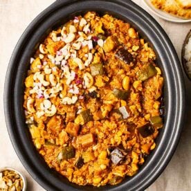 Vegetarian slow cooker curry in a slow cooker topped with cashew nuts.