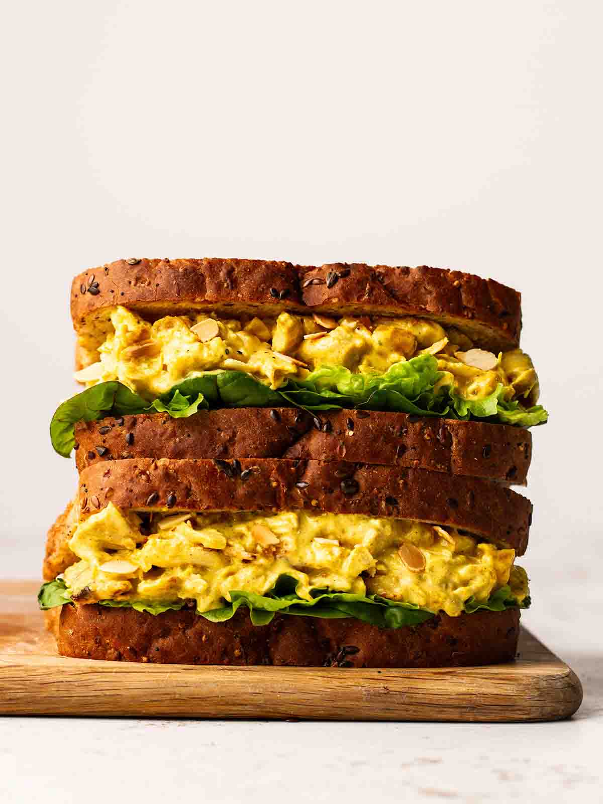 A side view of a Coronation Chicken Sandwich, filled with lettuce and ready to eat.