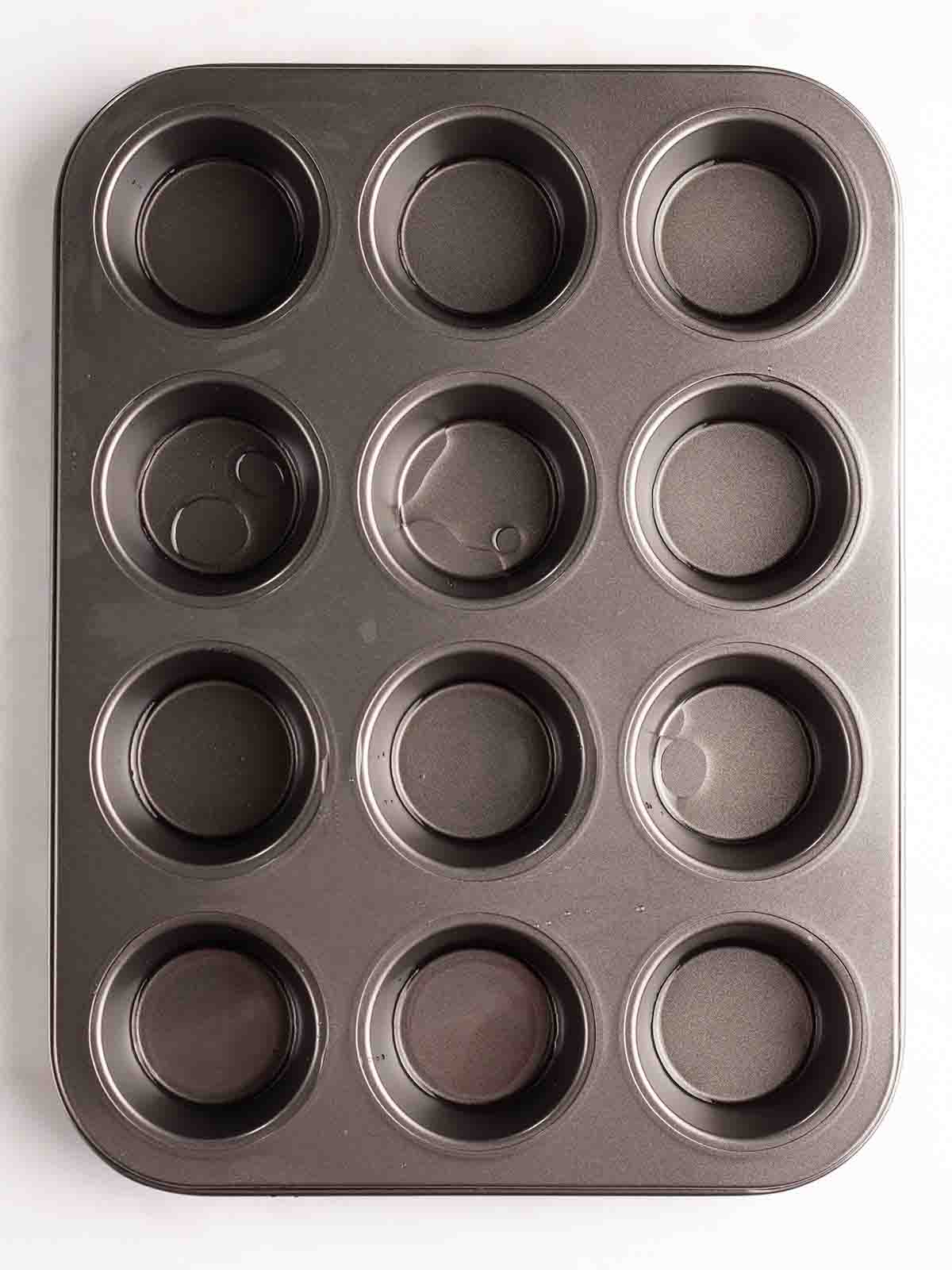A muffin tray filled with a little oil in the bottom of each hole for the recipe for Yorkshire Puddings.