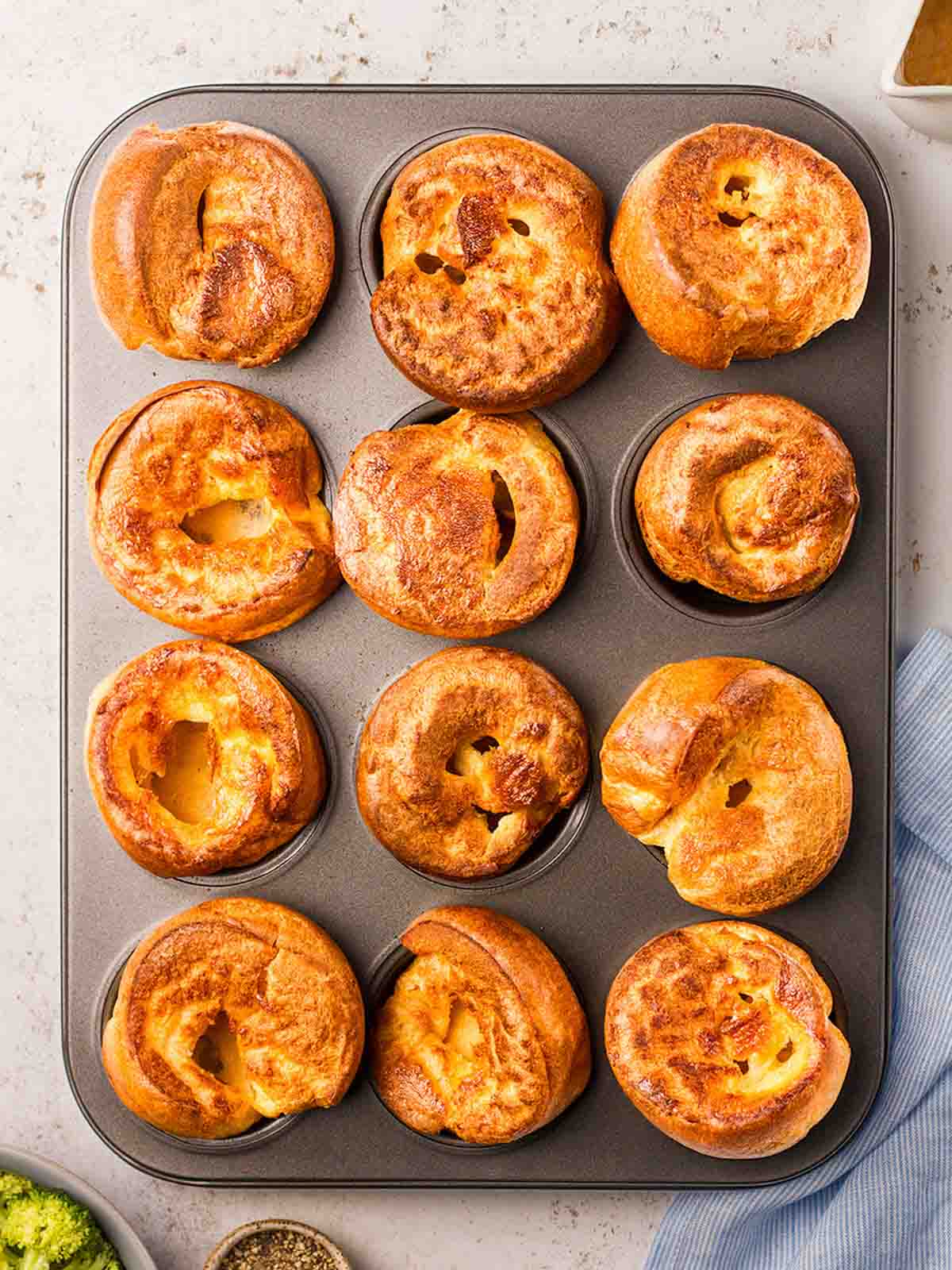 A muffin tray filled with 12 perfect Yorkshire Puddings, ready to eat.