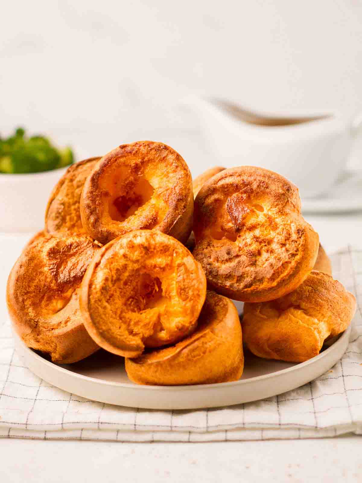 A plate filled with a pile of Yorkshire Puddings.