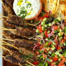 Lamb kofta kebabs recipe with flatbreads and Greek salad and tzatziki.