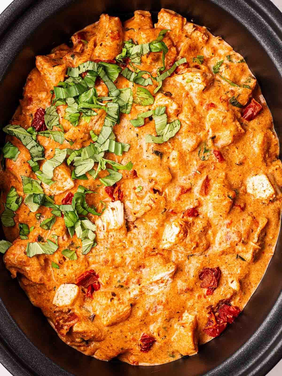 A close up of cooked Slow Cooker Marry Me Chicken in the pan.