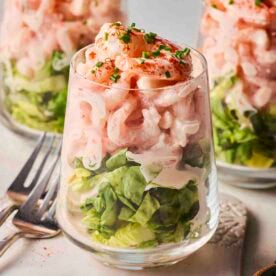 A close up of a classic Prawn Cocktail, with two more in the background, ready to eat.