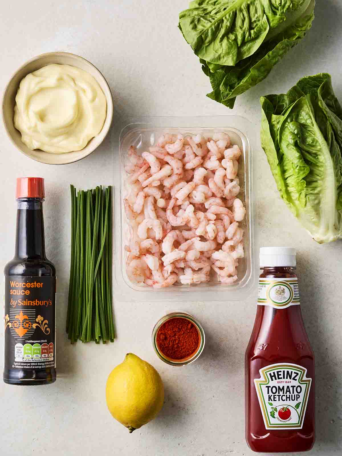 The ingredients for making Prawn Cocktail laid out on a white counter top.