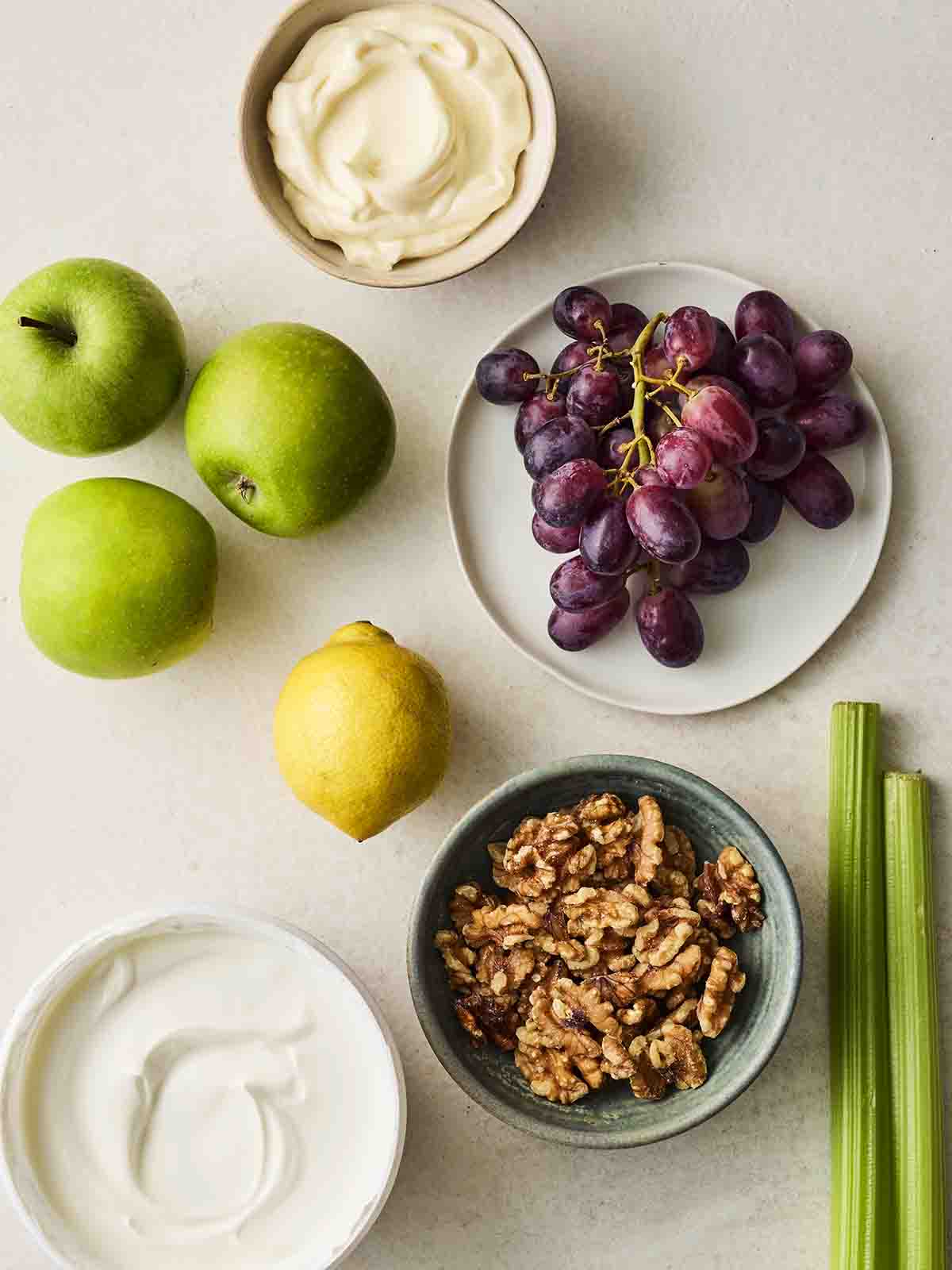 The ingredients for making a Waldorf Salad laid out on a counter top.