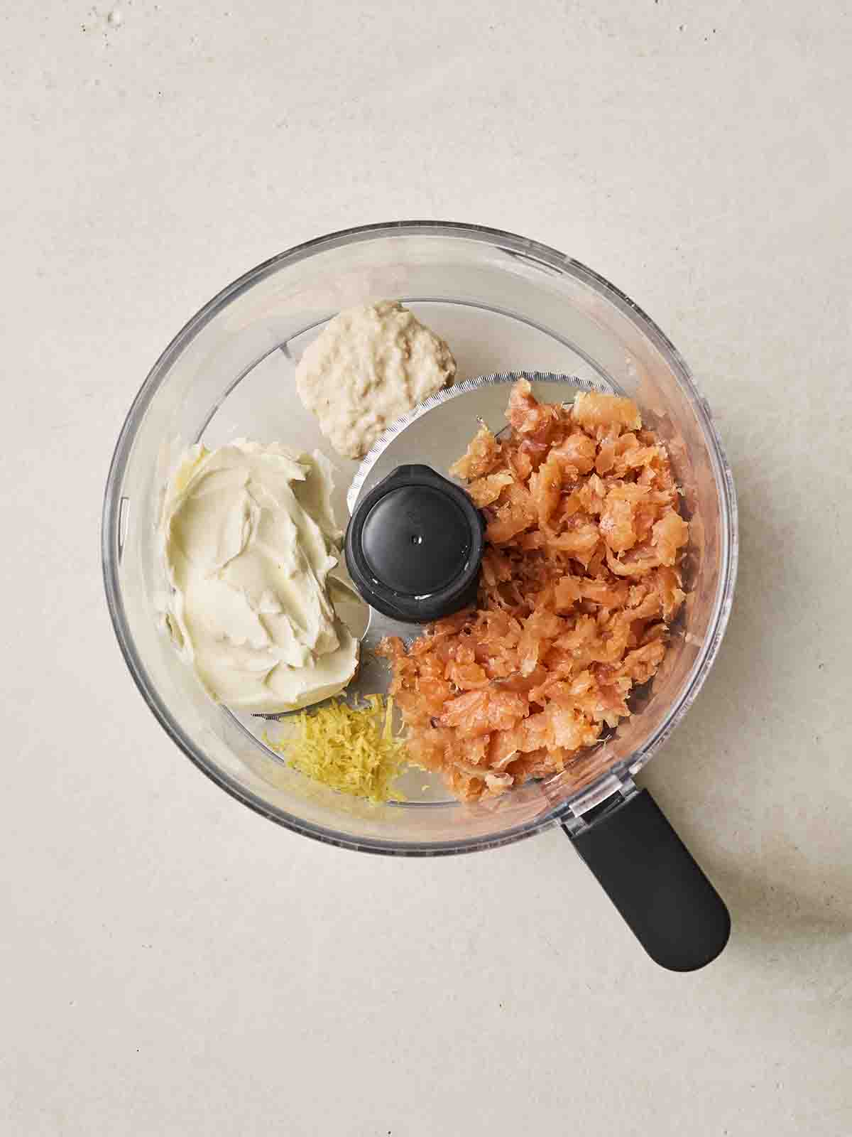 A food processor with salmon pate ingredients inside, for step 1 in the recipe.