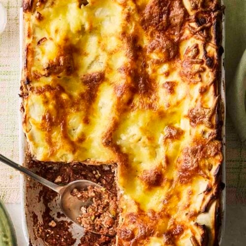 A vegetarian lasagne with a piece cut out.