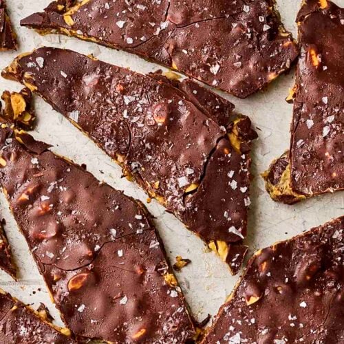 A broken piece of homemade date snack with peanut butter and chocolate.