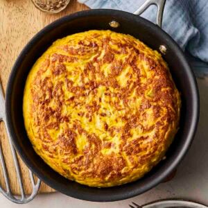 A pan on a table filled with a Spanish Omelette.