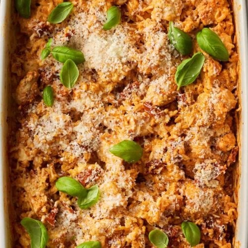 A dish filled with cooked chicken and rice, all cooked in one pan.